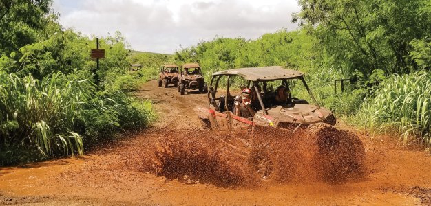 a truck driving down a dirt road