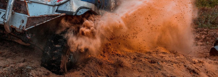 a truck driving down a dirt road